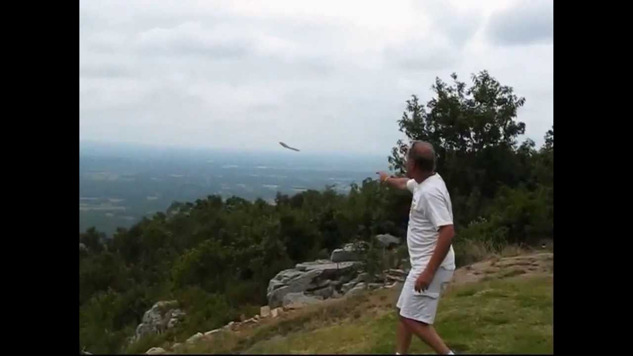 Mike launching an OmniWing off the edge of Mount Nebo, the wing already far out over the valley