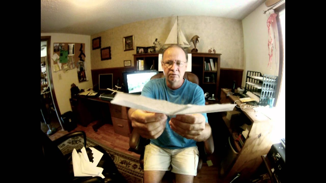 Mike Kelsey at his desk in 2011, holding an OmniWing up to the camera